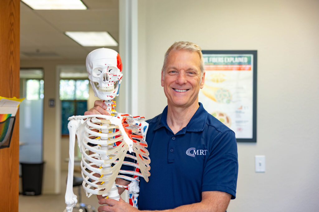 Mark Rise evaluating back pain at Muscle Restoration Therapy, Fort Collins.