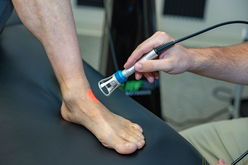 Class 4 laser treatment on a foot at Muscle Restoration Therapy, Fort Collins.