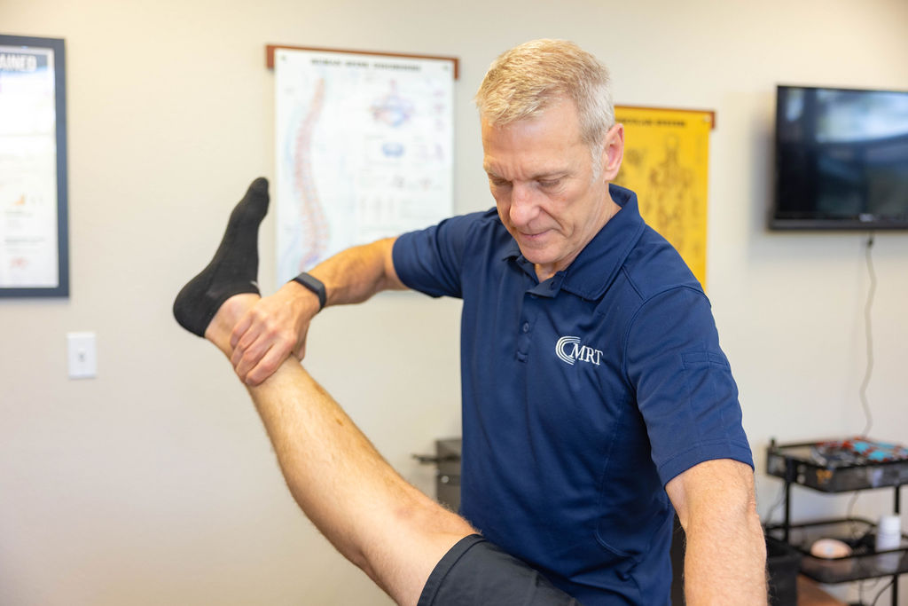 Mark Rise evaluating foot and leg muscles at Muscle Restoration Therapy, Fort Collins.