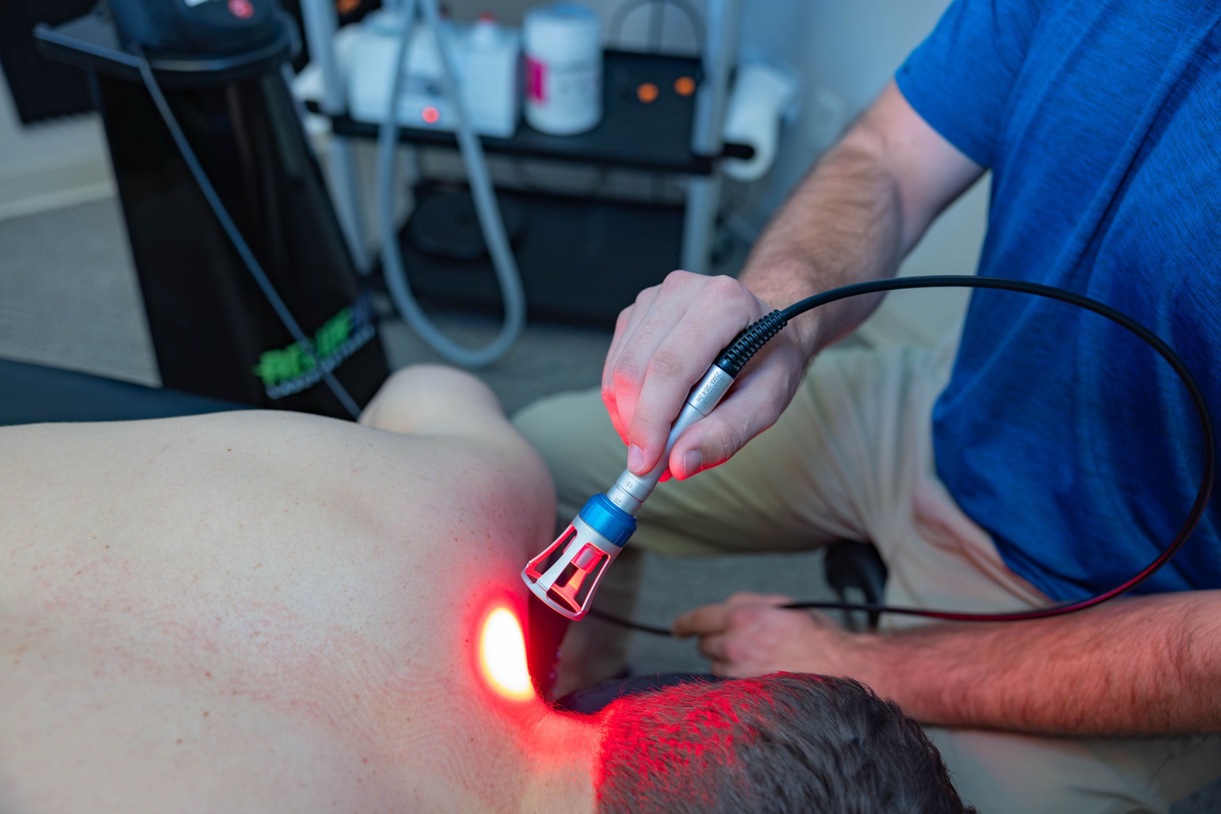 Class IV laser on a client's upper back and neck at Muscle Restoration Therapy, Fort Collins.